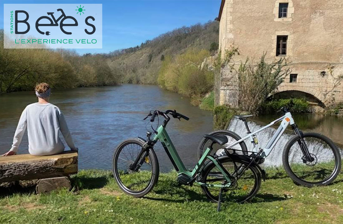 Bicycle rental near lush river scenery in Dordogne.