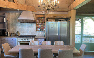 Cozy Dordogne Vacation Home Kitchen Charming kitchen in Domaine du Tilleu with rustic wooden beams and modern appliances. Perfect for re.