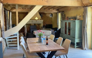 Cozy Dining Area in Domaine du Tilleu Charming rustic dining space with wooden beams, chandelier, and modern furniture in Domaine du Tille.