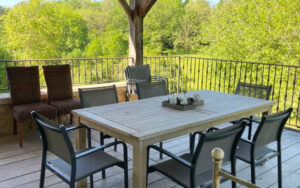 Cozy outdoor dining area at Domaine du Tilleu Outdoor dining terrace with scenic forest view at Domaine du Tilleu.