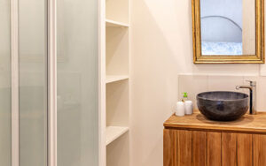Modern bathroom with shower and wooden vanity in Dordogne holiday house.