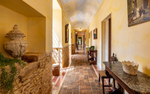 Elegant corridor in a luxury Dordogne holiday home with rustic decor.