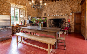 Cozy rustic living room in a Dordogne holiday house with stone walls and vintage furniture.