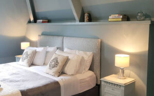 Elegant bedroom in luxury Dordogne holiday home with cozy decor.