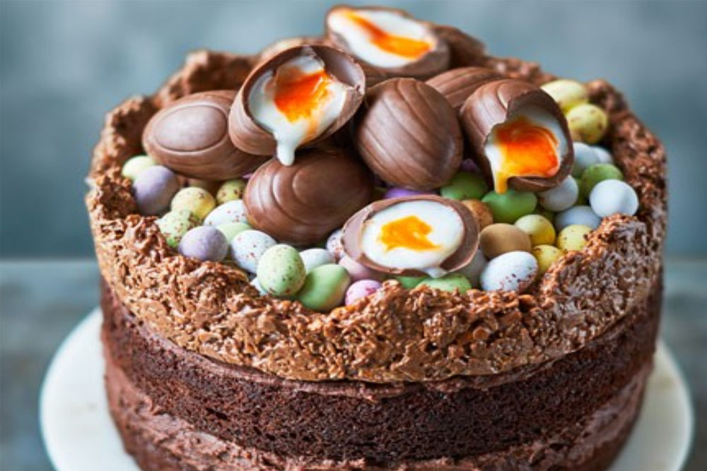 Delicious chocolate Easter cake decorated with mini eggs and chocolate eggs, perfect for festive cel.
