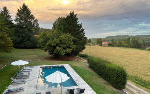 Gezicht op het zwembad en de landelijke omgeving in Dordogne.