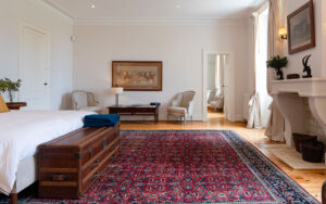 Luxe slaapkamer met antieke meubels en traditioneel tapijt.
